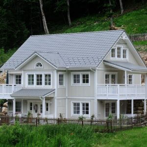 large house on a forested hillside