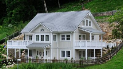 large house on a forested hillside