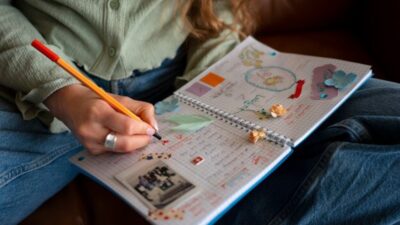 a redhead woman doing some creative journaling