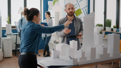 A team of colleagues analyzes the layout and model of the building