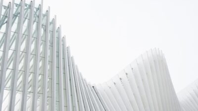 Horizontal shot abstract buildings with white metallic ribs and glass windows