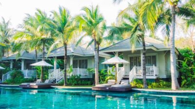 Poolside bungalows nestled among lush palms