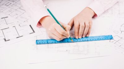 A woman works with architecture plans