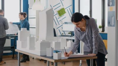 Woman Architect Analyzing Blueprints Plan